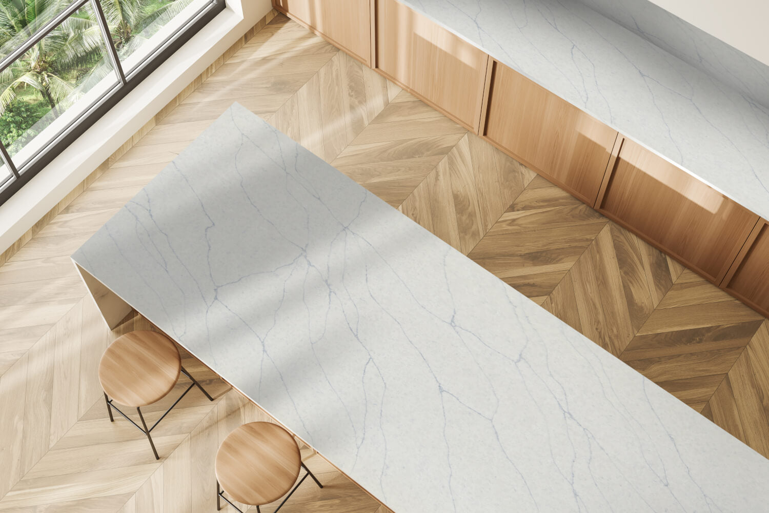 Modern kitchen with a marble island and wooden floor.