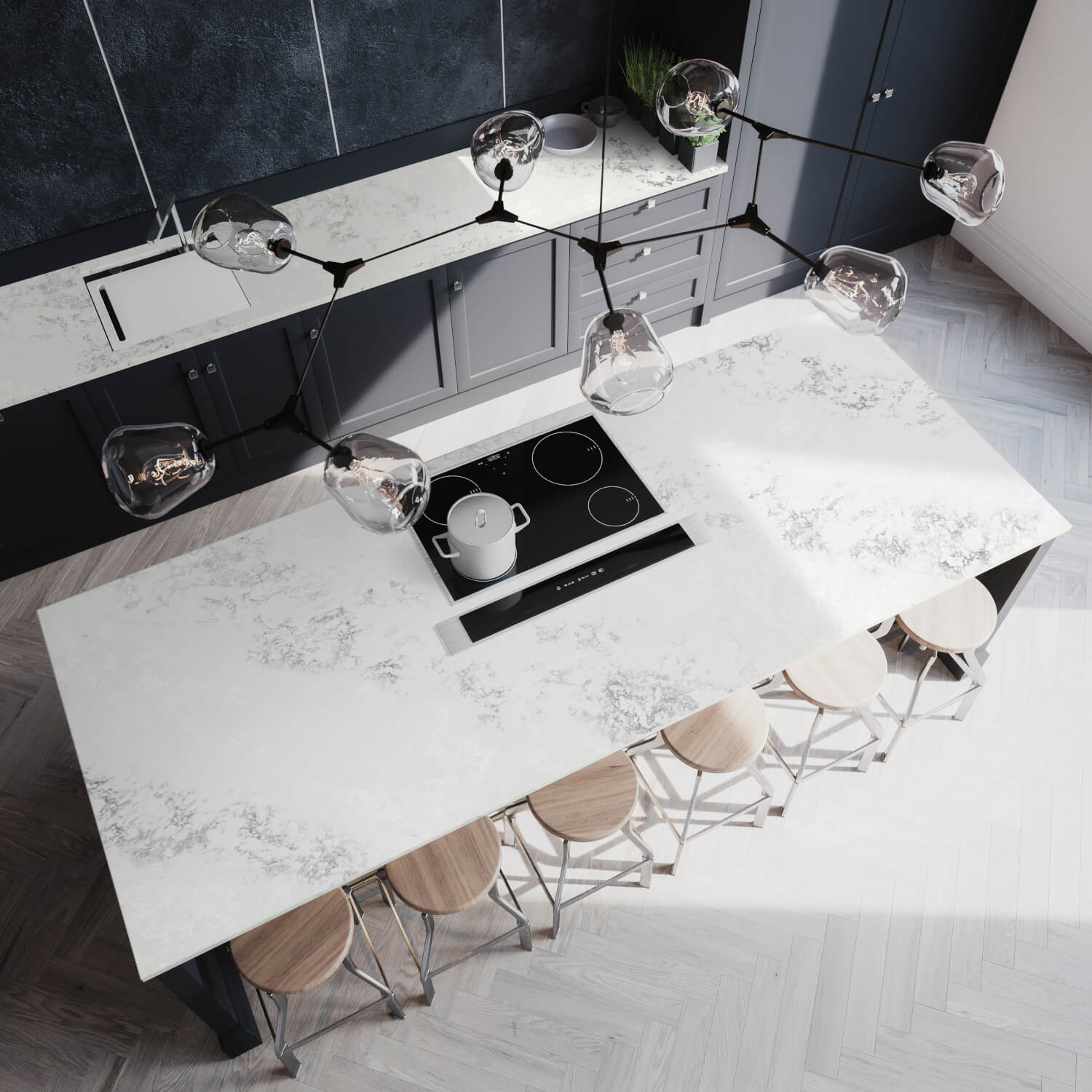 Modern kitchen with marble countertop, stove, and chairs.