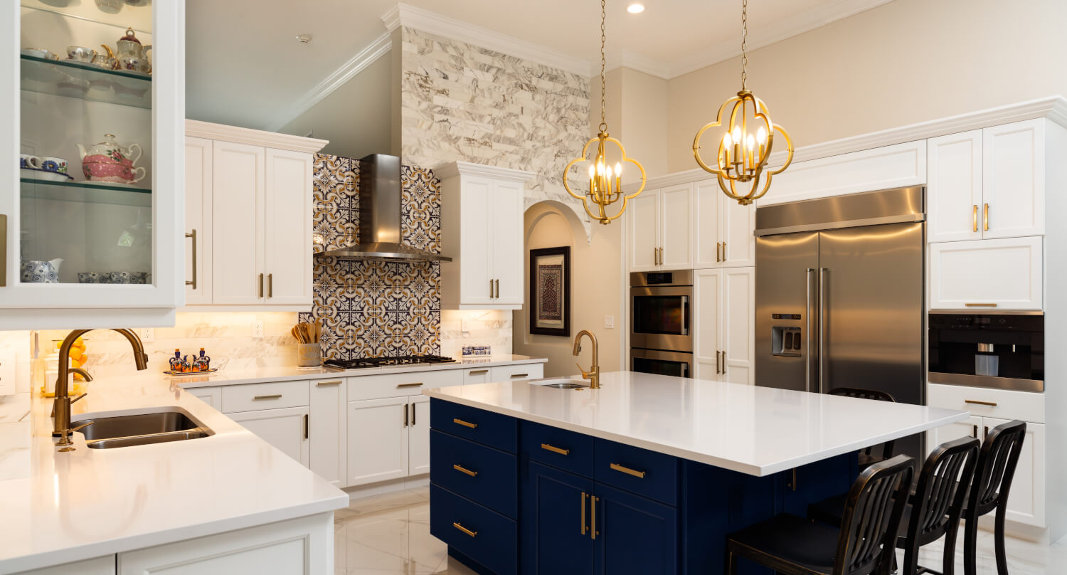 Modern kitchen with white cabinets, stainless steel appliances, and a blue island.