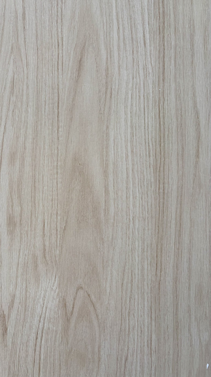 Close-up of a wooden surface with a light brown color and visible grain pattern.