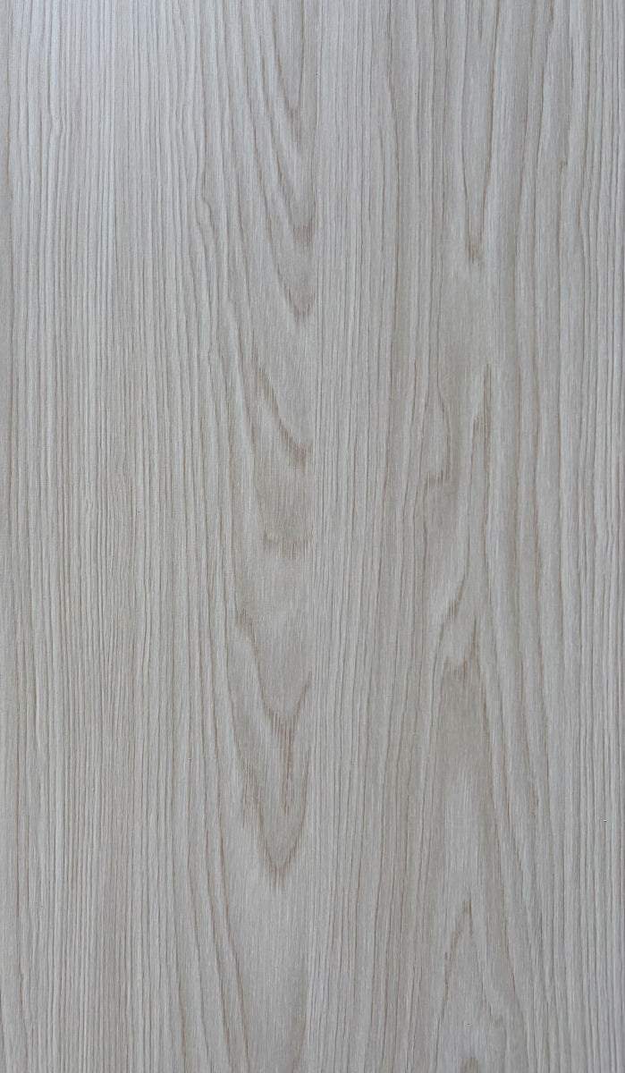 Close-up of a wooden surface with a light brown color and visible grain pattern.