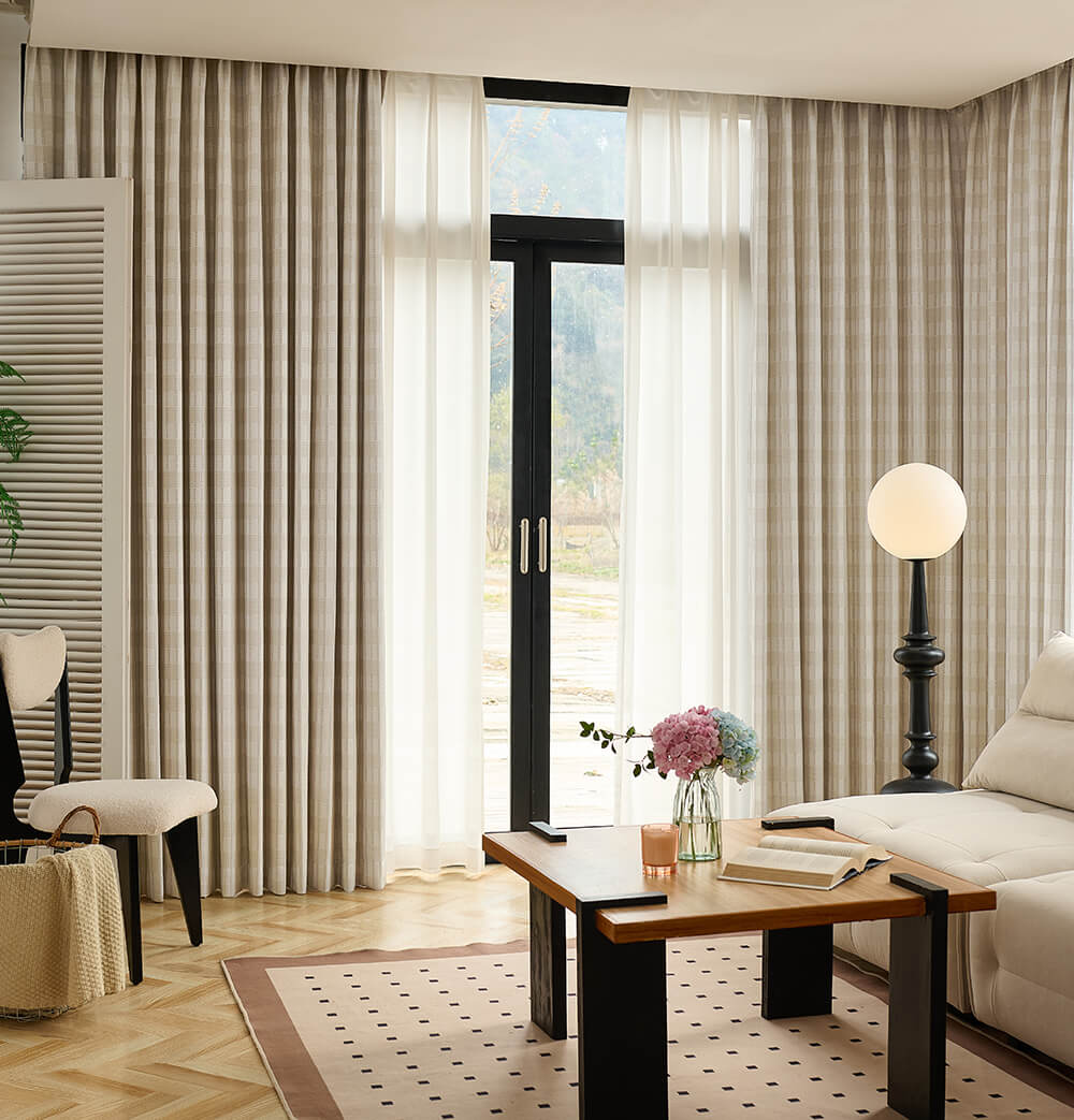 Living room with striped curtains, a coffee table, and a lamp.